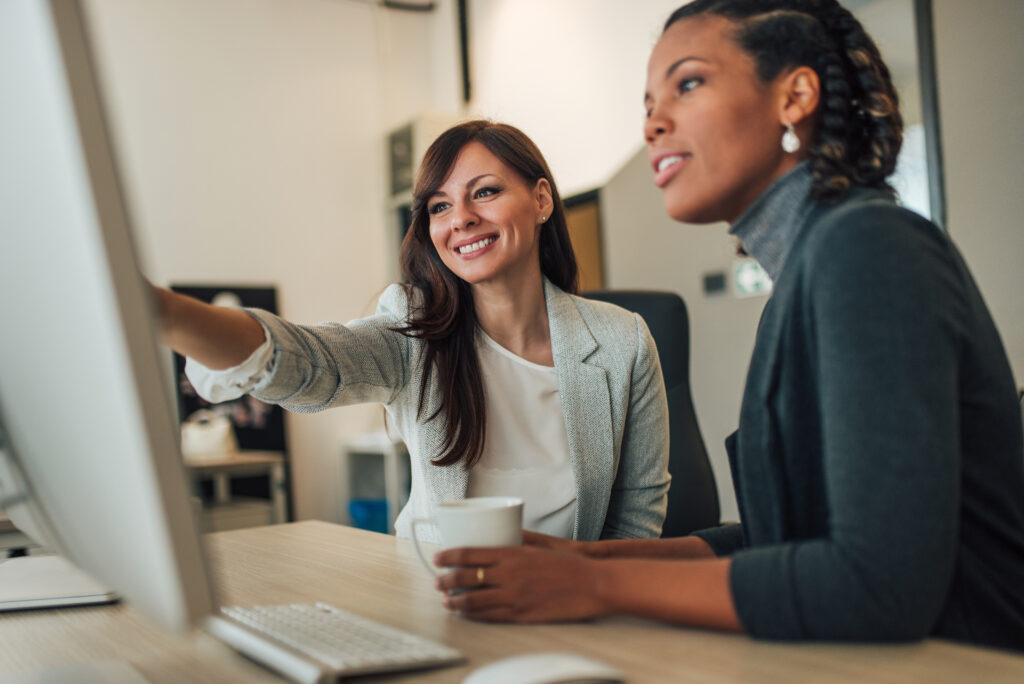 Two beautiful women working together in the office.